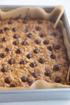 a baking pan filled with oatmeal and chocolate chips