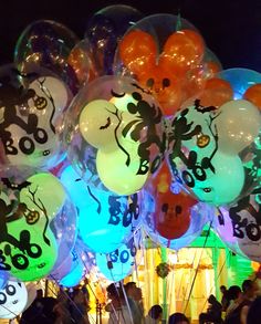 a bunch of balloons that are in the shape of cartoon characters on display at an outdoor event