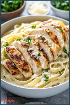 chicken alfredo with parsley in a white bowl