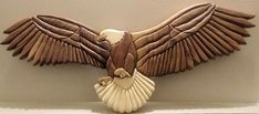 an eagle sculpture on the wall with its wings spread