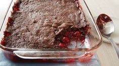 a chocolate cake in a glass dish on a table