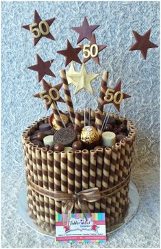 a 50th birthday cake with chocolate stars and candies in the shape of number 50