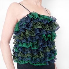 a woman wearing a green and blue knitted top