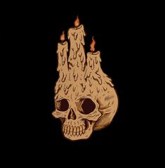 a wooden skull with burning candles on it