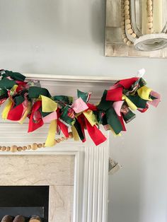 a fireplace mantel decorated with colorful paper streamers