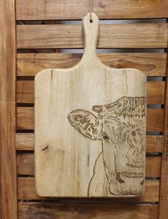 a wooden cutting board with an image of a giraffe on it