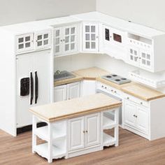 a model kitchen with white cabinets and counters