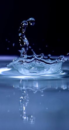 water splashing on top of a blue surface