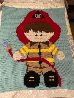 a crocheted afghan with a fireman on it