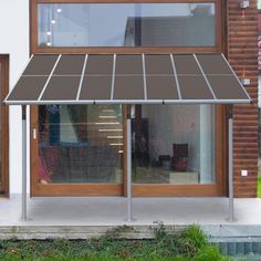 an awning on the side of a building in front of a door and windows