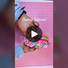 the video shows how to sew a flowered purse with scissors and fabric material