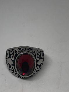 Vintage Red Ruby Glass Mens Ring Stainless Steel Deco design about half an inch Cool Vintage Rock and Roll star men's ring Nice heavy ring, Stainless Steel Unused stock from the 1980's I have an assortment of sizes from 7 - 9 - 10 - 11 - 12 or 13 ONLY. Please add your size to the order in a message and I will send the size you require. If I am out of stock in your size, I will list the ones I have available for replacement. If I am sold out in the sizes you would prefer, I will cancel and refund Simple Ruby Mens Rings Vintage, Retro Red Ring Jewelry, Luxury Handmade Ruby Men's Ring, Vintage Red Nickel-free Jewelry, Mens Ruby Ring Silver, Red Sterling Silver Ruby Ring Hallmarked, Mens Stainless Steel Rings, Cool Vintage, Vintage Gothic