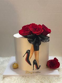 a white cake decorated with red roses and high heels