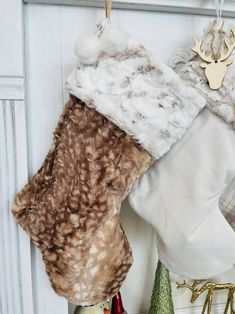 two christmas stockings hanging from hooks on the wall next to other holiday decorations and ornaments