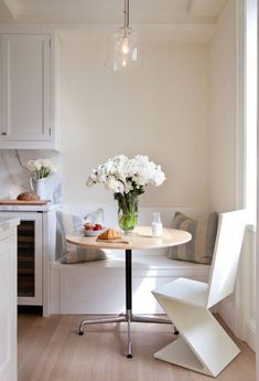 a small table with flowers in a vase on it