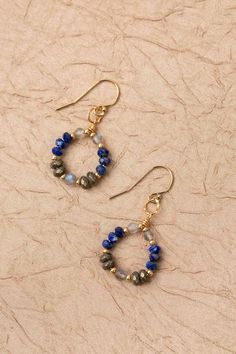 From the Blue Moon collection, these earrings come is a fun hoop design with shades of blue and elements of gold.. Gold Filled (nickel and lead-safe) Lapis, Pyrite, Labradorite 1.5", with gold filled ear wires We hand select our natural materials, thus there may be slight variations in color and/or size that will not detract from the overall aesthetic Our unique handcrafted designer jewelry for women is made in America, each design created individually in our personal design studio in Floyd VA U Gemstone Beaded Earrings, Blue Hoop Brass Jewelry, Blue Brass Hoop Jewelry, Nickel-free 14k Gold-filled Blue Jewelry, Nickel Free 14k Gold-filled Blue Jewelry, Blue 14k Gold-filled Nickel-free Jewelry, Blue 14k Gold Filled Nickel-free Jewelry, Nickel-free Blue Small Hoop Jewelry, Blue 14k Gold Filled Hoop Jewelry