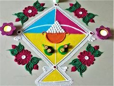 a colorful kite with flowers and candles on it