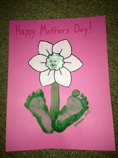 a pink card with two baby feet and a flower on it that says happy mother's day