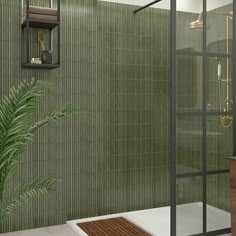 a green tiled bathroom with a plant in the corner and a shower stall on the side