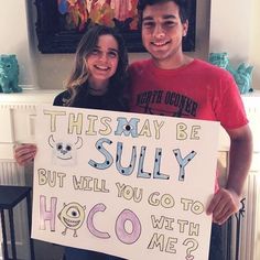 a man and woman holding a sign that says, this may be sully but will you go to hog with me?