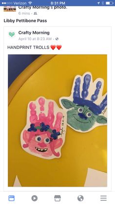 two handprints with different designs on them sitting on top of a yellow table