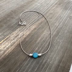 This simple yet stunning necklace is handcrafted from high-quality silk cord, featuring a minimalist design that adds sophistication to any outfit. The centerpiece is a stunning apatite coin bead (6mm), known for its blue-green hue and associated with determination and creativity.  On either side are sterling silver rondelle beads.   This necklace is available in black or gray silk cord.  Please select your preferred color and length.  It is designed to be a comfortable choker length, however th Gemstone Choker Necklace, Apatite Necklace, Blue Choker, Boho Wrap Bracelet, Beaded Earrings Diy, Gemstone Choker, Diy Gemstone, Silver Silk, Earrings Diy