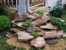 a pile of rocks sitting in front of a house