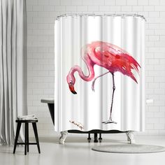 a pink flamingo shower curtain hanging in a bathroom