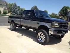 a black pickup truck parked in a driveway