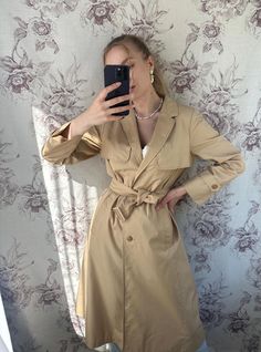 A vintage light fall trench coat in a timeless camel color, featuring an elegant belted waist that enhances the silhouette. This women's trench coat combines classic style with functionality, perfect for layering during cooler seasons. Its versatile and sophisticated design makes it a staple piece for any wardrobe. - Good vintage condition (has small black stains, see close up photo) - TAG SIZE: no information  - Fabric information: no information  Estimated to fit XS-S-M-L based on your desired Fall Trench Coat, Fall Trench, Trench Coat Fall, Light Fall, Coat Elegant, Photo Tag, Black Stains, Trench Coats Women, Camel Color