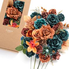 a bouquet of flowers sitting on top of a table next to a box with an envelope