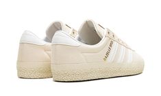 The adidas Gazelle SPZL "Chalk White" is a cream-based colorway of the retro shoe by adidas archivalist and Spezial founder Gary Aspden’s collaboration.  From adidas’s Autumn/Winter 2023 collection, the adidas Gazelle SPZL “Chalk White” is a modern take on the classic silhouette that fuses elements of adidas Gazelles from the 1960s, 1970s, and 1980s.  The upper has a Chalk White canvas construction with white leather Three Stripes branding on the sides.  A gold “Gazelle SPZL” logo is printed on the lateral side of the mid-panel.  Classic “adidas” detailing can be seen on the tongue.  A white textured rubber sole completes the look. Adidas Cream Sneakers With Gum Sole, Vintage Cream Sneakers With Vulcanized Sole, Adidas Shoes Gazelle, Adidas S, Adidas Gazelles, Jordan Golf, Stripes Branding, Vapormax Nike, Nike X Travis Scott