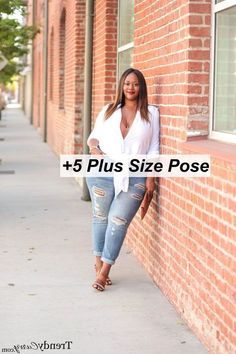 a woman leaning against a brick wall with the words 5 plus size pose