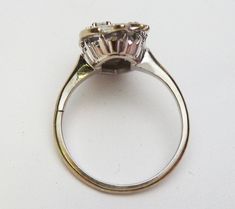 "This is a long diamond dinner ring from the 1960's. It would make a great right hand ring :) The ring is 14 karat white gold and is a long free form shape. It has a diamond set in the center and also at the bottom of the ring there are 4 smaller round diamonds. The top of the ring has a carved design which gives the illusion of more diamonds. The 5 stones have a combined total weight of 0.11 carats. The larger stone is I1 clarity and H color. The 4 smaller stones have SI-VS clarity and H color. Silver Pear-shaped Diamond Ring With Single Cut Diamonds, Diamond White Pear-shaped Cluster Ring For Formal Occasions, Vintage Pear-shaped Diamond Ring With Brilliant Cut, Silver Pear-shaped Diamond Ring With Single Cut, Pear-shaped Silver Diamond Ring With Single Cut Diamonds, Vintage Pear-shaped Brilliant Cut Diamond Ring, Formal Pear-shaped Cluster Ring In Diamond White, Formal Diamond White Pear-shaped Cluster Ring, Formal Pear-shaped Diamond White Cluster Ring