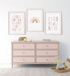 a baby's room with pink furniture and pictures on the wall, including a rocking horse