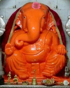 an orange elephant statue sitting on top of a table