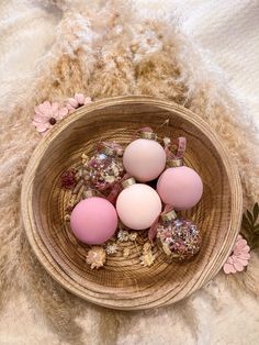 four eggs in a basket with flowers on the side