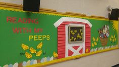 a classroom wall decorated with an image of a red barn and green background reads reading with my pees