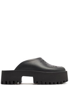 55mm Platform heel. Perforated GG rubber upper. Unlined. Treaded rubber sole Gucci Slip-on Mules, Gucci Leather Mules, Gucci Leather Mules With Round Toe, Gucci Black Mules With Round Toe, Black Gucci Mules With Round Toe, Gucci Slip-on Sandals With Rubber Sole, Modern Gucci Sandals With Round Toe, Gucci Open Toe Mules With Branded Insole, Gucci Leather Slip-on Sandals