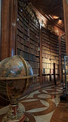 an old globe sits in the middle of a library