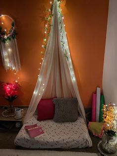 a bed with a white canopy over it in a room filled with books and decorations