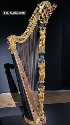 an ornate golden harp on display in a museum