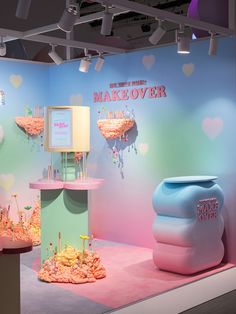 a display in the shape of an ice cream shop with pink, blue and green walls