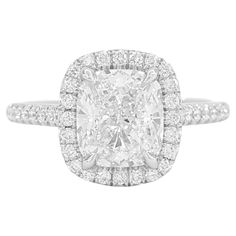 a cushion cut diamond ring with pave set shoulders