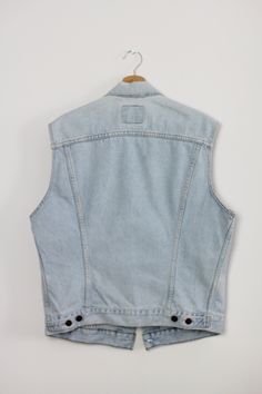 Vintage Levi's vest *For women *Classic lightblue denim *Upcycled pockets with floral fabric *Excellent condition - no flaws *100% Cotton - does not stretch Size: XL Bust: 44,75 inch / 114 cm Length: 24,5 inch / 62 cm More vests from my shop: https://www.etsy.com/shop/sisuvintagestore?section_id=21314725 --- SHIPPING --- Please allow to two working days for shipping after purchase. Every parcel is shipped as registered priority. Shipping takes to 7-15 working days. You can check my other shop wi Washed Blue Sleeveless Denim Vest With Pockets, Washed Blue Sleeveless Vest With Pockets, Washed Blue Cotton Vest With Pockets, Light Wash Sleeveless Cotton Denim Jacket, Sleeveless Light Wash Cotton Denim Jacket, Light Wash Denim Sleeveless Vest, Light Wash Sleeveless Denim Vest With Pockets, Light Wash Sleeveless Denim Vest, Sleeveless Light Wash Denim Jacket