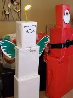 three boxes stacked on top of each other with santa's face painted on them