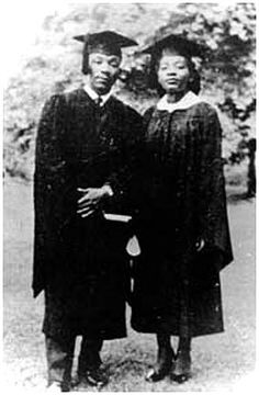 an old black and white photo of two people in graduation gowns standing next to each other