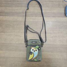 Chala Handbags Owl Gen A Cellphone Crossbody Handbag-Convertible Strapdimensions: 5" X 7.5" X 1" Strap Adjustable: 7"~30" Small Front Pocket Adorned With Our Owl A Design Adjustable Strap - Turn Bag Into A Purse, A Crossbody Bag, Or Even A Pouch! Top Zipper Closure Leaf Zipper Pull Soft Lining Inside 3 Credit Card Slots Inside 2 Adjustable Straps That Are Detachable Extra Padding Throughout Bag To Protect Your Cell Phone Materials: Faux Leather Color: Olive Description: Owl A - Cell Phone Xbody Casual Phone Bag With Detachable Strap, Satchel Shape, Casual Satchel Phone Bag With Detachable Strap, Casual Phone Bag With Detachable Strap, Casual Phone Shoulder Bag With Detachable Strap, Casual Green Portable Phone Bag, Casual Green Phone Bag, Casual Pouch Phone Bag For On-the-go, Casual Phone Shoulder Bag With Removable Pouch, Green Phone Bag With Detachable Strap For Travel