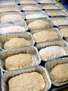 several pans filled with dough sitting on top of a table