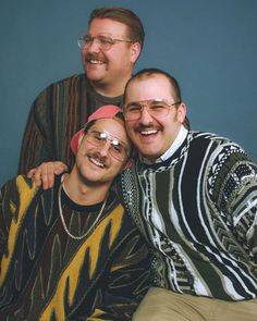 three men are posing for a photo together